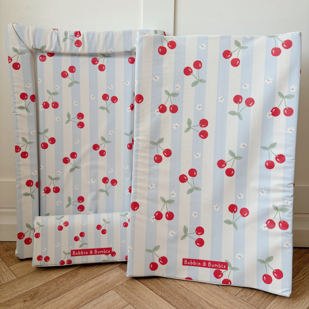 Changing mat bundle with cherry pattern on a wooden floor