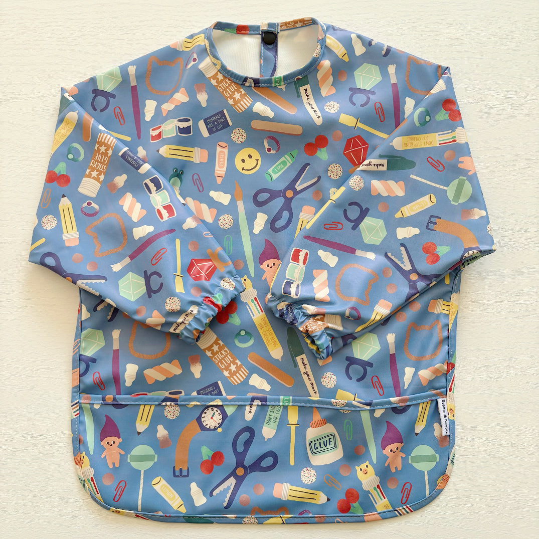 Colorful children's apron with various patterns on a light background