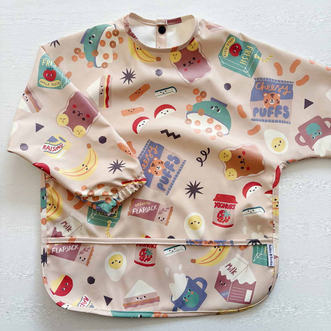 Baby bib with colorful food-themed print on a white background