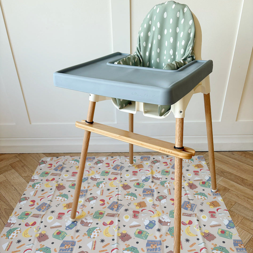High chair with a green cushion on a patterned mat