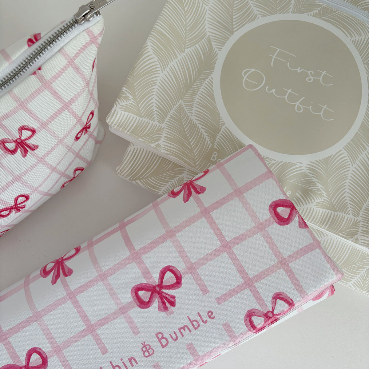 hospital bag pouches, nappy wallet and a travel baby changing mat with Bobbin and Bumble branding on a light background