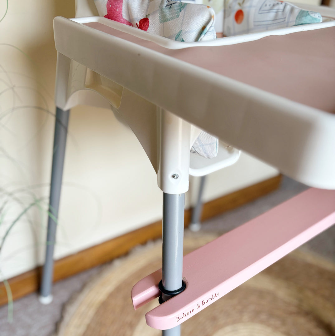 Pink IKEA highchair accessories with 'Bobbin & Bumble' branding in a home setting.