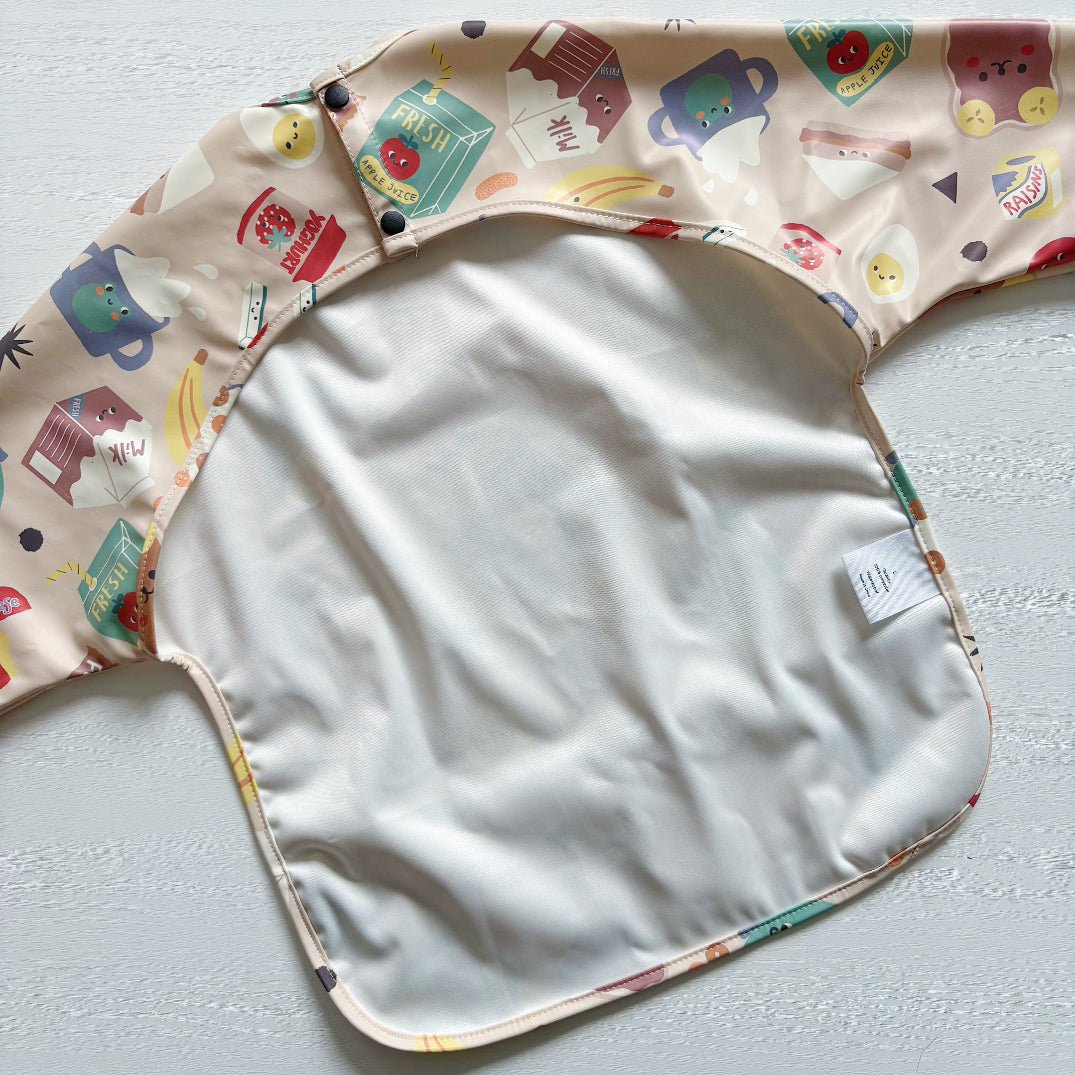 Baby bib with colorful cartoon designs on a light background