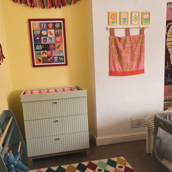 Children's room with colorful decor, furniture, and toys.