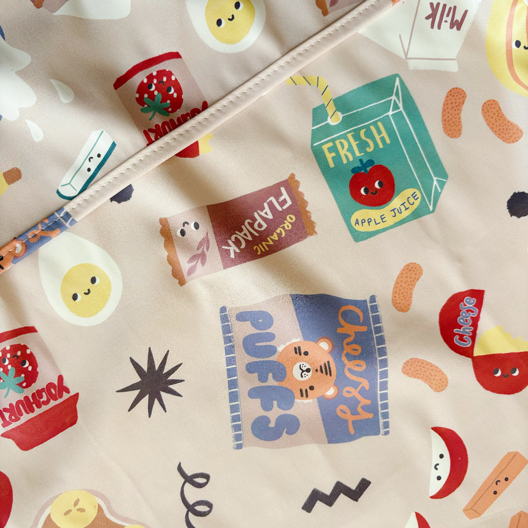 Patterned fabric with cartoon food items and text on a beige background