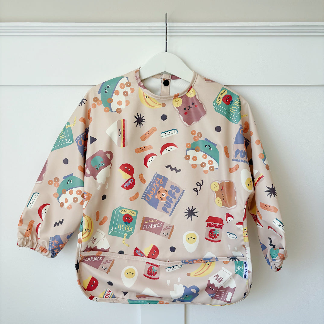 Children's bib with a colourful fun food pattern on a white background