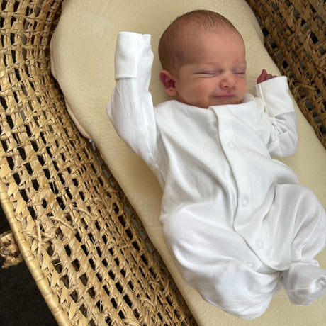 sleeping baby on a new moses basket mattress