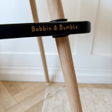 Bobbin and Bumble logo on black highchair footrest