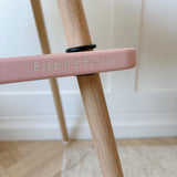bobbin and bumble logo on a pink IKEA highchair footrest