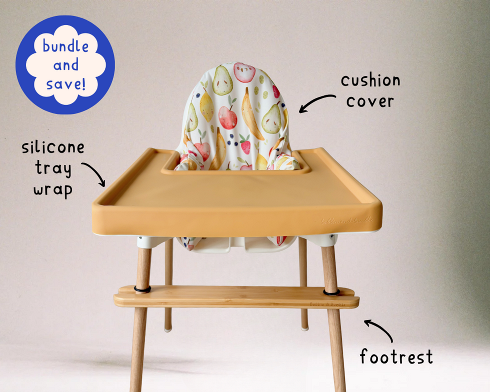 Wooden high chair with cushion cover, silicone tray wrap, vinyl leg wraps, and footrest on a light background.