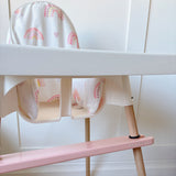 IKEA highchair with rainbow cushion and pink footrest
