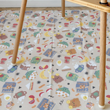 Patterned play mat on a wooden floor with a chair